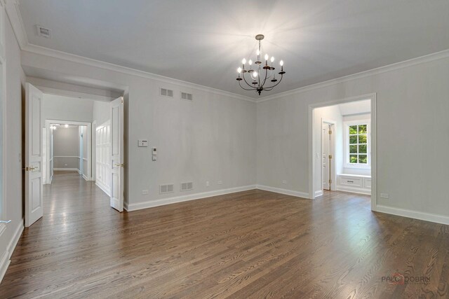 empty room with an inviting chandelier, crown molding, and wood-type flooring