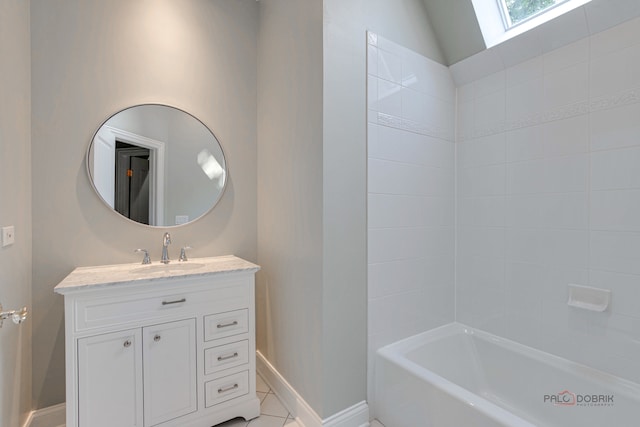 bathroom featuring tile patterned flooring, lofted ceiling with skylight, vanity, and tiled shower / bath