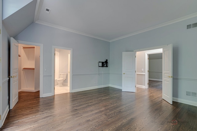 interior space featuring hardwood / wood-style flooring, vaulted ceiling, ensuite bath, and ornamental molding