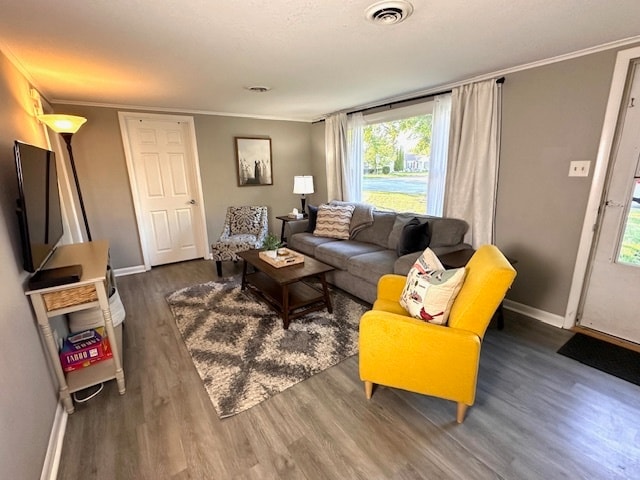 living room with dark wood-type flooring and crown molding