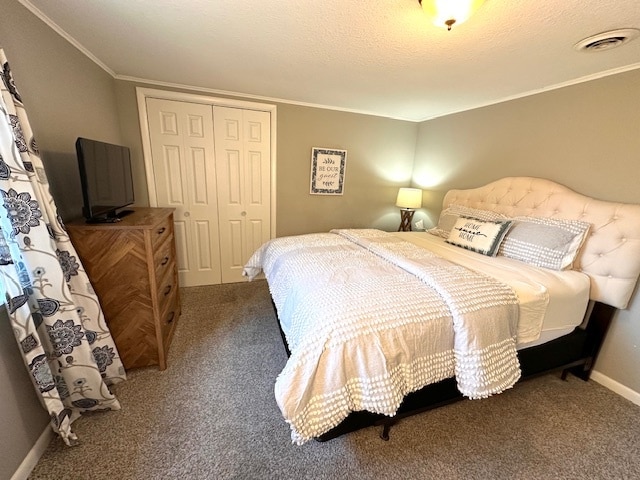 bedroom with a closet, carpet flooring, and crown molding