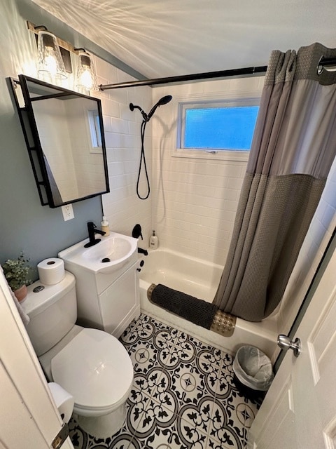 full bathroom featuring shower / bath combo with shower curtain, sink, toilet, and tile patterned flooring