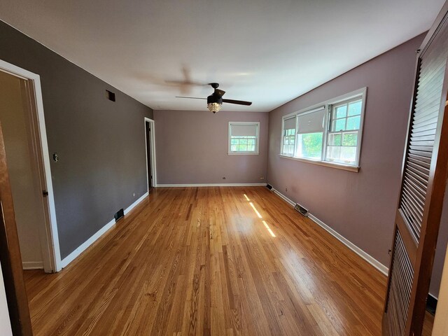 spare room with wood-type flooring and ceiling fan