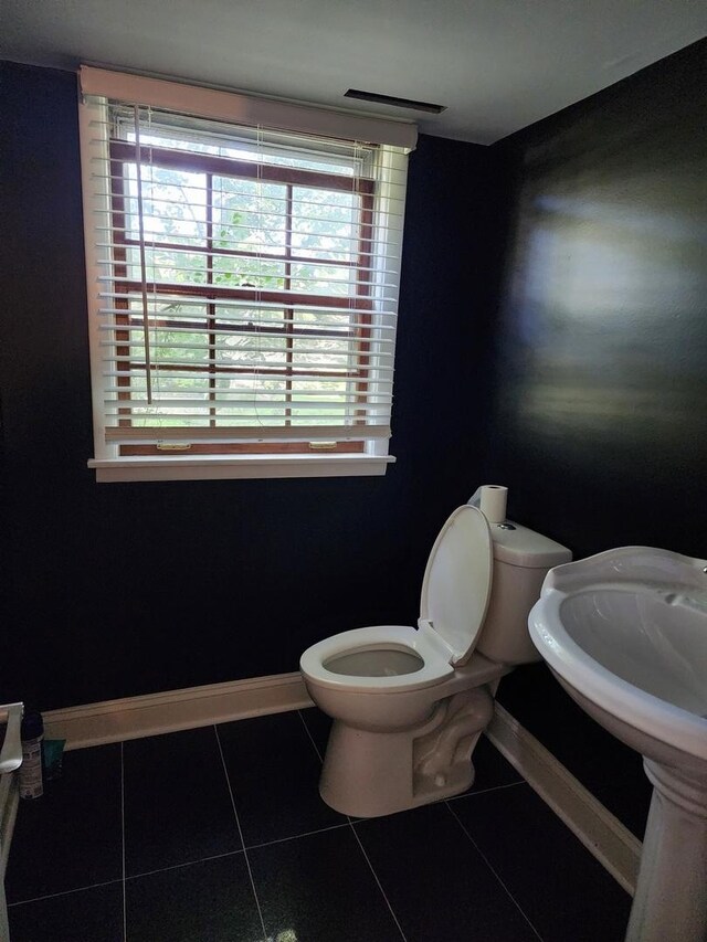 bathroom featuring tile patterned flooring and toilet