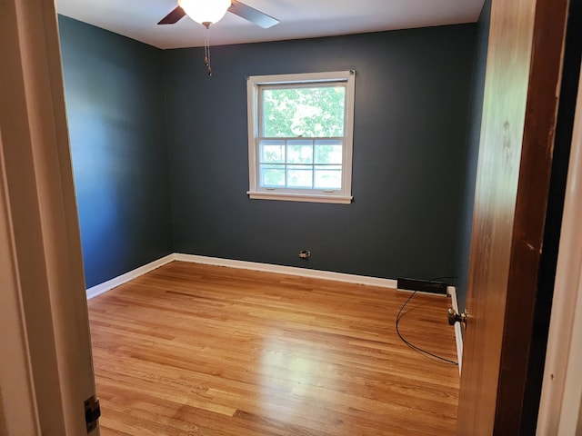 empty room featuring light wood-type flooring and ceiling fan