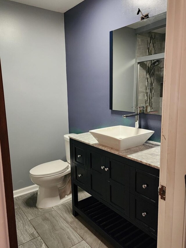 bathroom with vanity, tile patterned flooring, and toilet