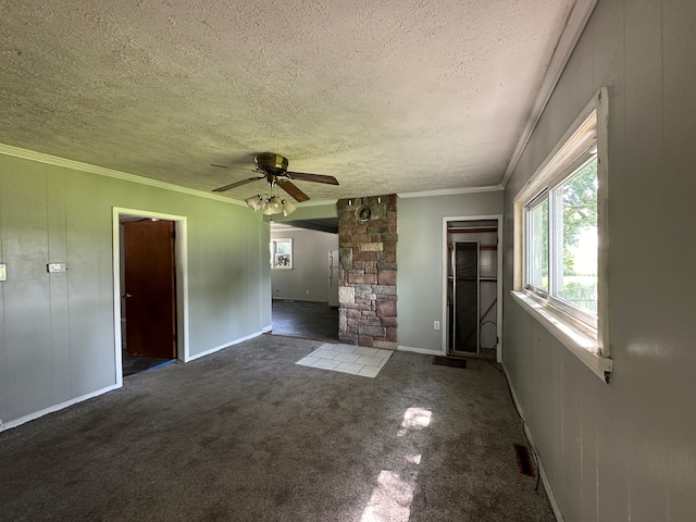 unfurnished living room featuring ceiling fan, carpet flooring, a textured ceiling, and crown molding