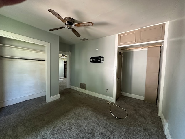 unfurnished bedroom featuring dark colored carpet, ceiling fan, and a closet