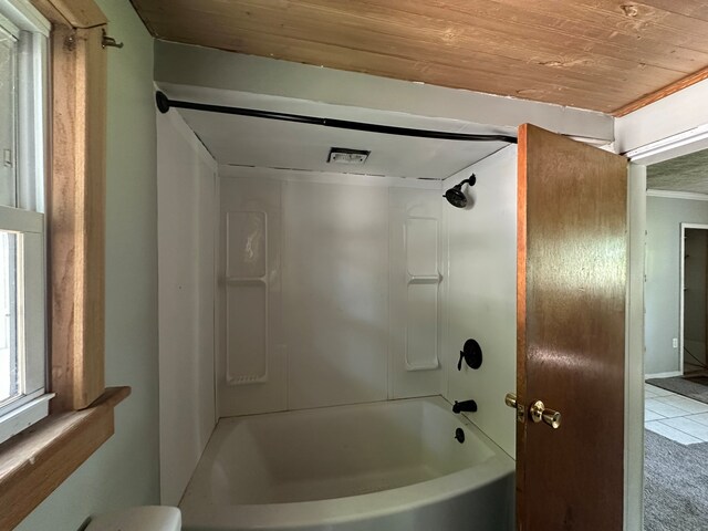 bathroom featuring tile patterned floors, washtub / shower combination, wood ceiling, and toilet