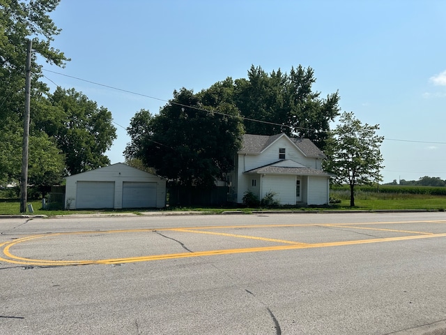 view of front of property featuring a garage and an outdoor structure