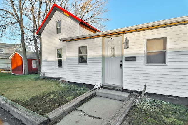 exterior space with a yard and a storage unit