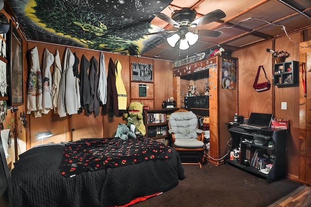 bedroom featuring carpet floors, ceiling fan, and wooden walls