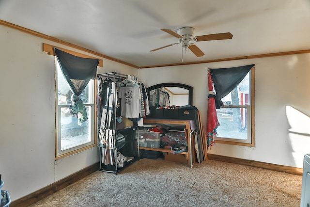 carpeted bedroom with ceiling fan and ornamental molding