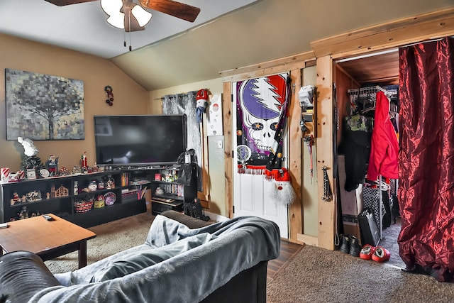 living room featuring carpet floors, ceiling fan, and vaulted ceiling