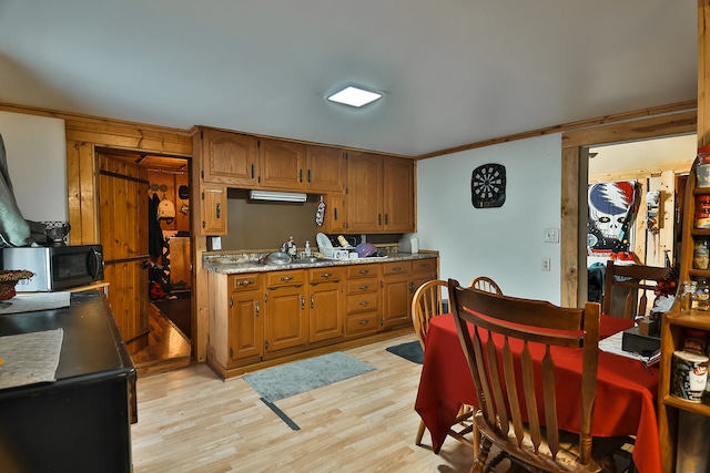 kitchen featuring light hardwood / wood-style floors and ornamental molding