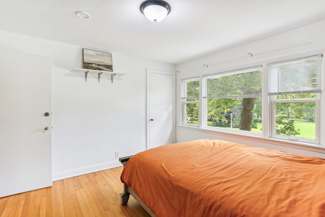 bedroom with light hardwood / wood-style flooring and a closet