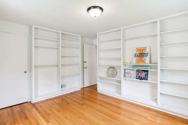 walk in closet with light wood-type flooring