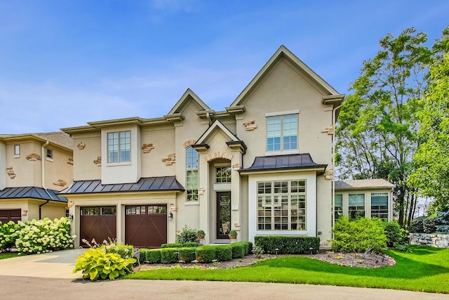 1 Willowcrest Dr, Oak Brook, IL 60523 - view of front of home with an attached garage, a standing seam roof, driveway, and stucco siding