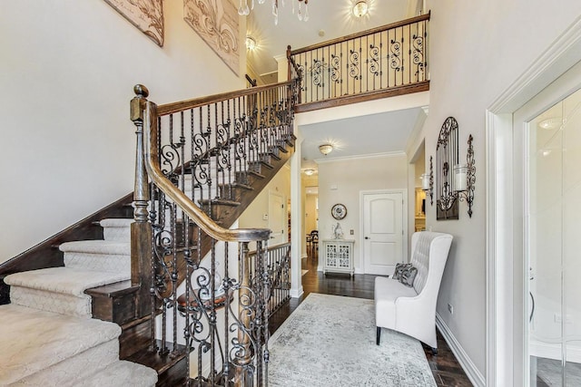 1 Willowcrest Dr, Oak Brook, IL 60523 - stairs featuring baseboards, ornamental molding, wood finished floors, and a towering ceiling