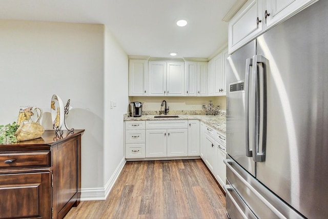1 Willowcrest Dr, Oak Brook, IL 60523 - kitchen with wood finished floors, a sink, baseboards, stainless steel fridge, and white cabinetry