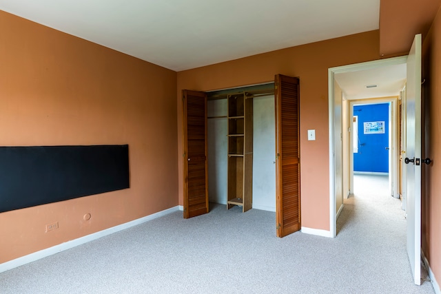 unfurnished bedroom featuring carpet and a closet