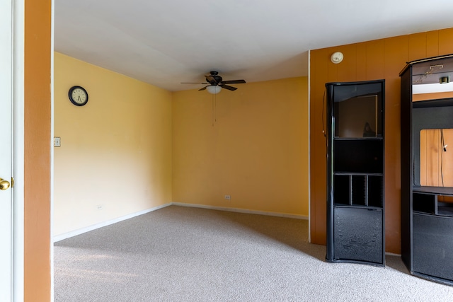 empty room with light colored carpet and ceiling fan