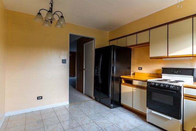 kitchen featuring white gas range, a chandelier, cream cabinetry, black fridge with ice dispenser, and light carpet