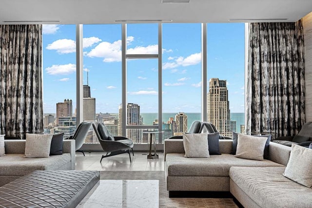 tiled living room with a wall of windows and a water view