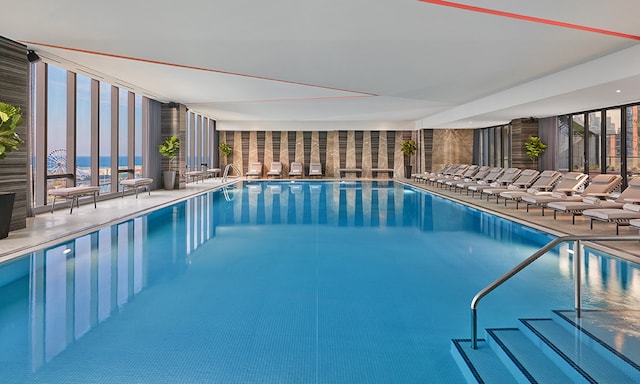 pool at dusk with a patio area