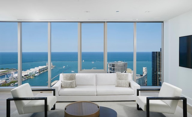 living room with a water view, plenty of natural light, and hardwood / wood-style floors