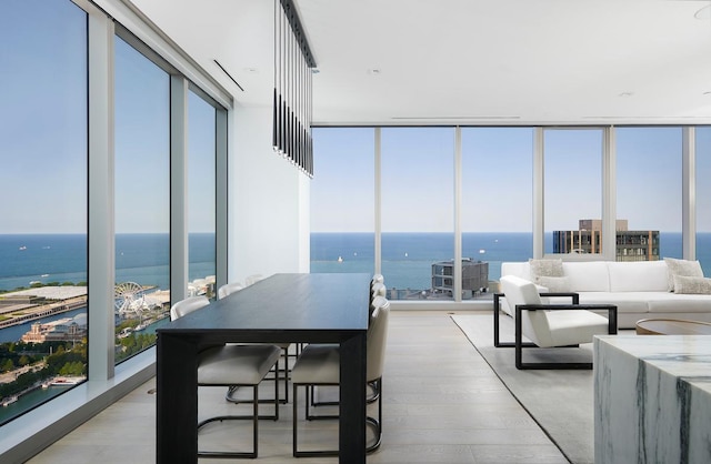 sunroom featuring a water view