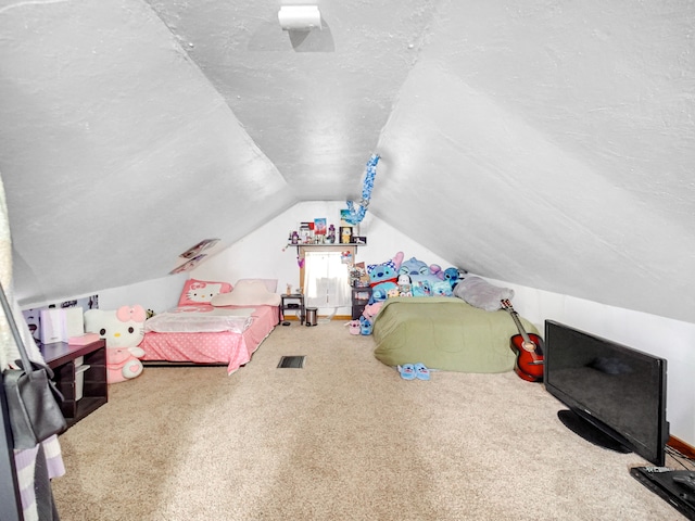 bedroom with carpet floors, a textured ceiling, and lofted ceiling