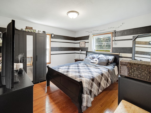 bedroom with hardwood / wood-style floors