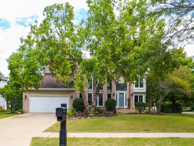 view of front of property with a front yard and a garage