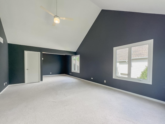 additional living space featuring ceiling fan, high vaulted ceiling, and light colored carpet