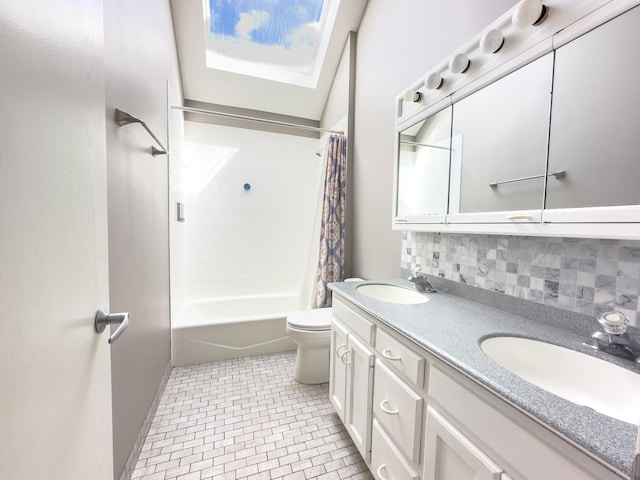 full bathroom featuring shower / bath combo, tasteful backsplash, a skylight, vanity, and toilet
