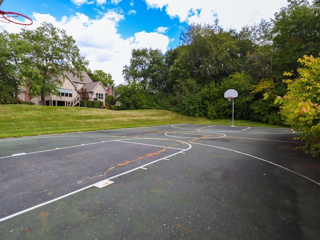 view of basketball court featuring a yard