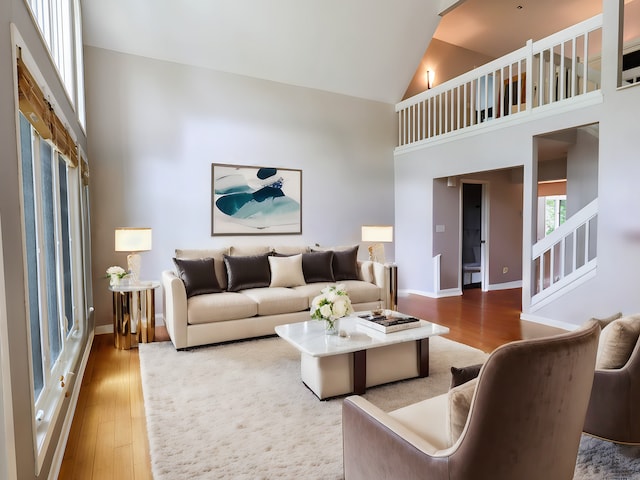 living room featuring hardwood / wood-style flooring and high vaulted ceiling