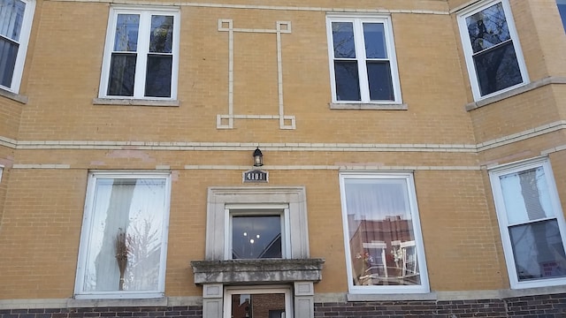 view of side of home with brick siding