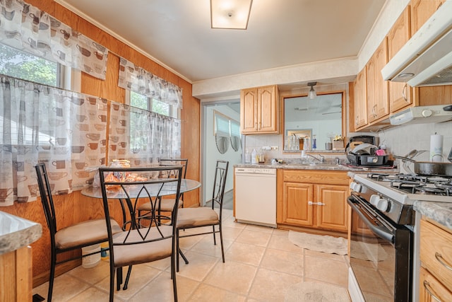 kitchen featuring white dishwasher, backsplash, light tile patterned floors, black gas range, and ornamental molding