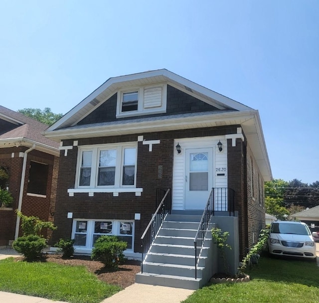 view of front of house featuring brick siding