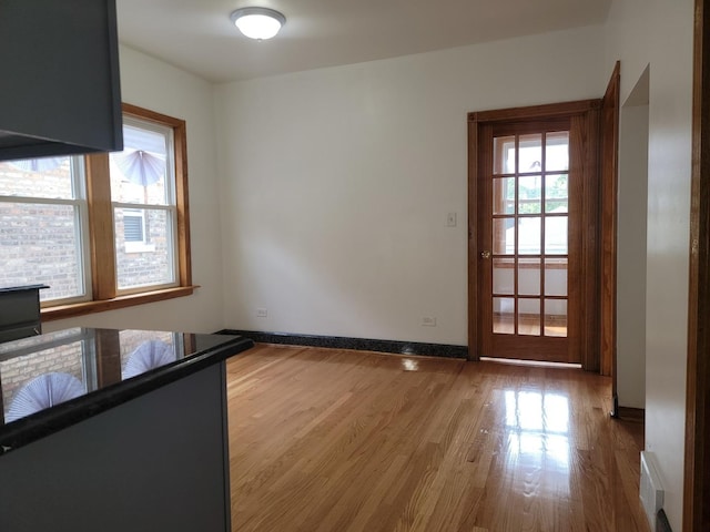 interior space featuring visible vents, baseboards, and wood finished floors