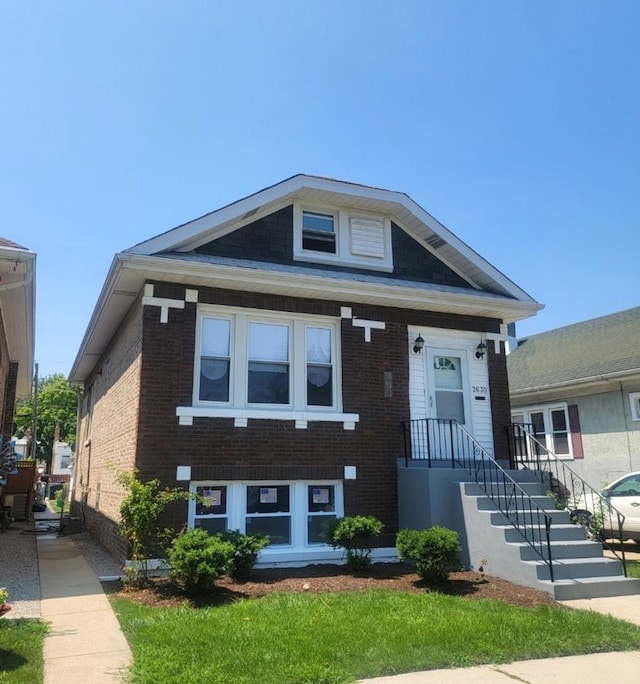 view of front of home featuring brick siding