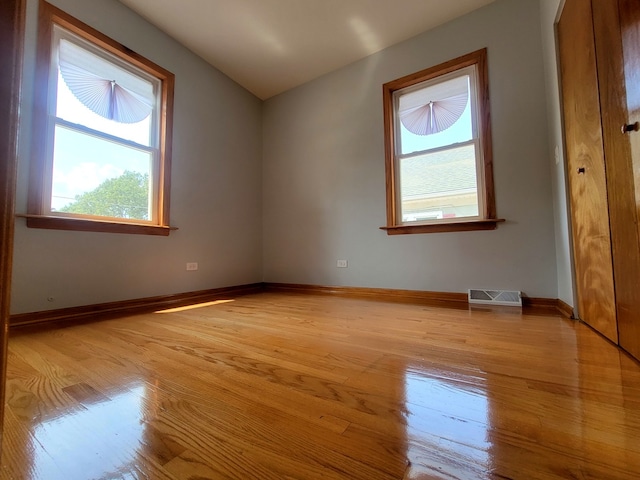 unfurnished room with light hardwood / wood-style floors and a healthy amount of sunlight