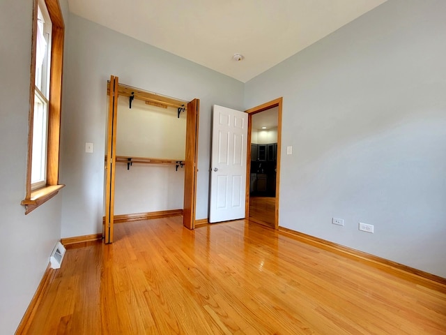 unfurnished bedroom featuring light wood-type flooring