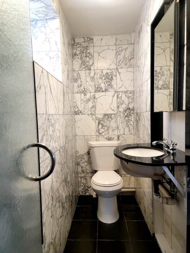 bathroom featuring tile walls, toilet, and tile patterned flooring