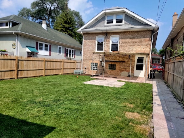 back of property with a yard, a patio area, and central AC unit