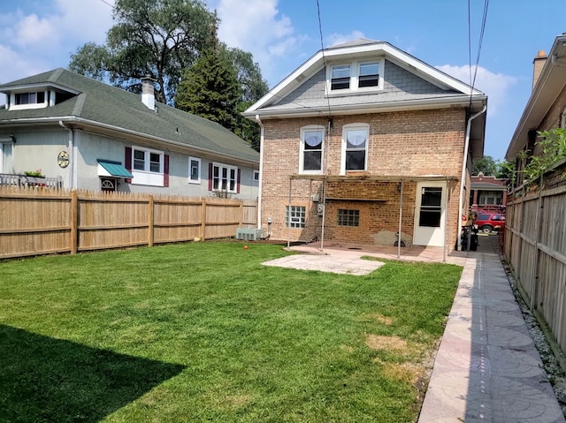 back of property featuring a yard, central air condition unit, and a patio