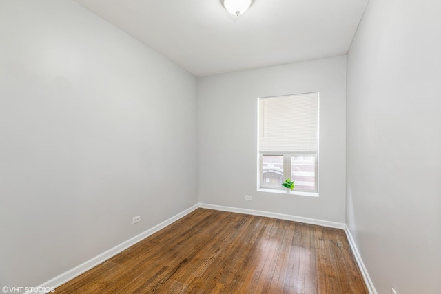 unfurnished room with baseboards and wood finished floors