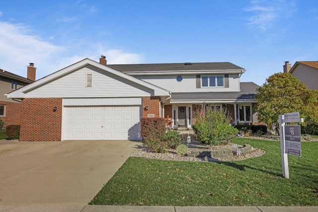 view of front of house featuring a garage and a front lawn